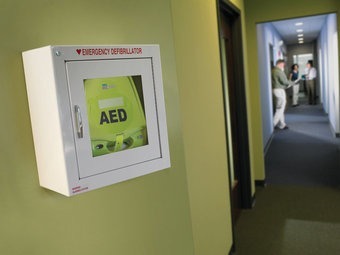 Zoll AED mounted in a cabinet in a hallway.