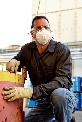 Man at workplace wearing a 3M Particulate Repirator