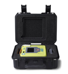Open view of the small ZOLL AED 3 carry case showing a ZOLL AED 3 and spare battery pack fitted inside.